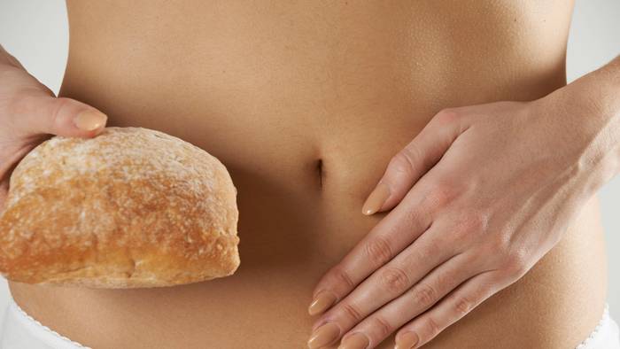 Eine Frau hält sich die Hand auf den Bauch. Der Darm ist ein Reizthema in Köln – wenn es um die Gesundheit geht.