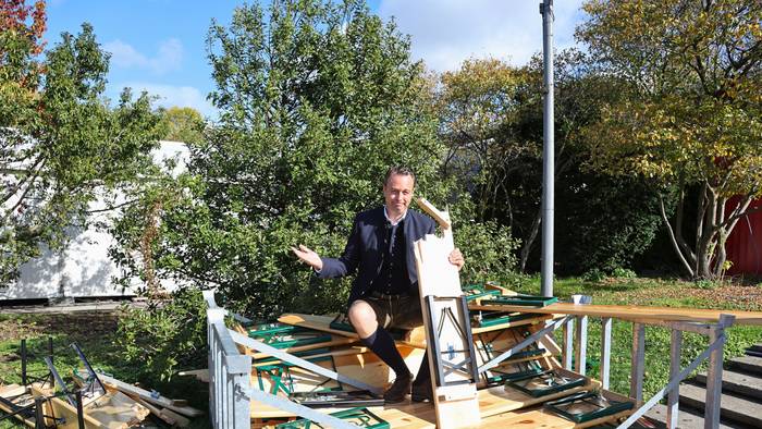Lukas Wachten sitzt auf den zerbrochenen Bänken der Royal Wiesn.
