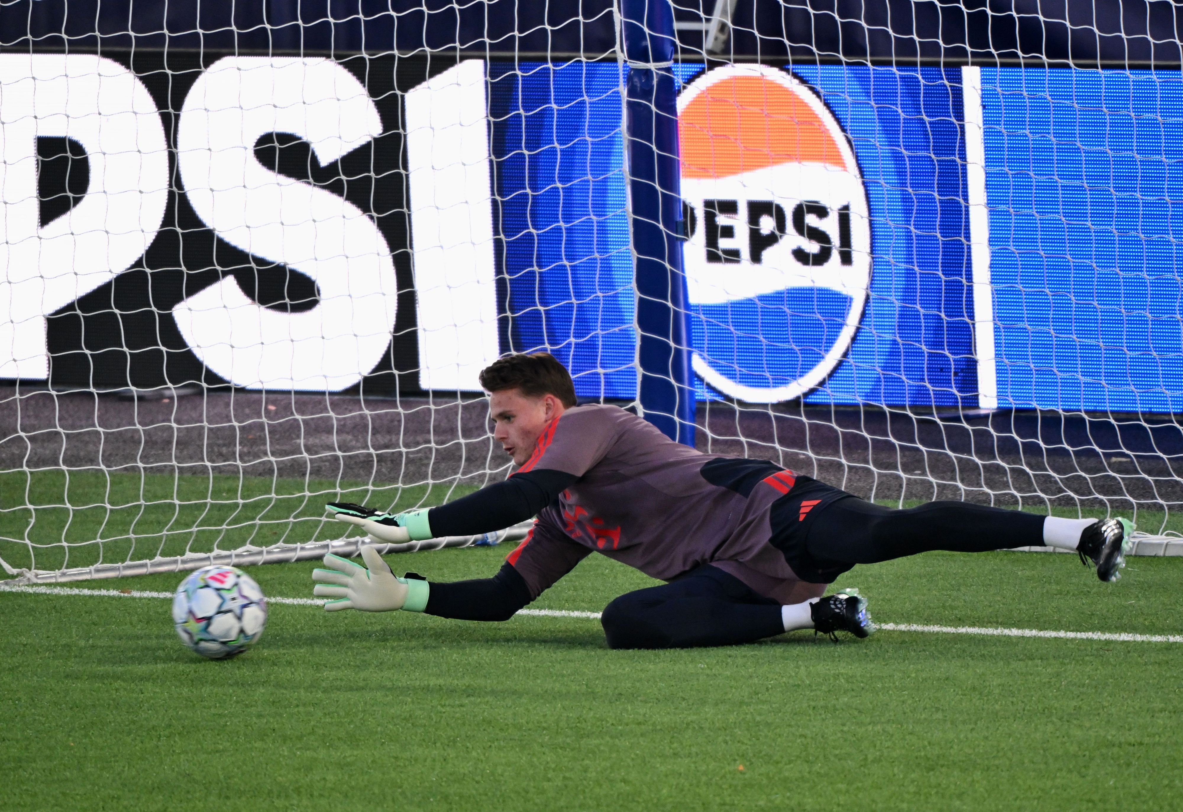 Jonas Urbig hält einen Ball im Training.