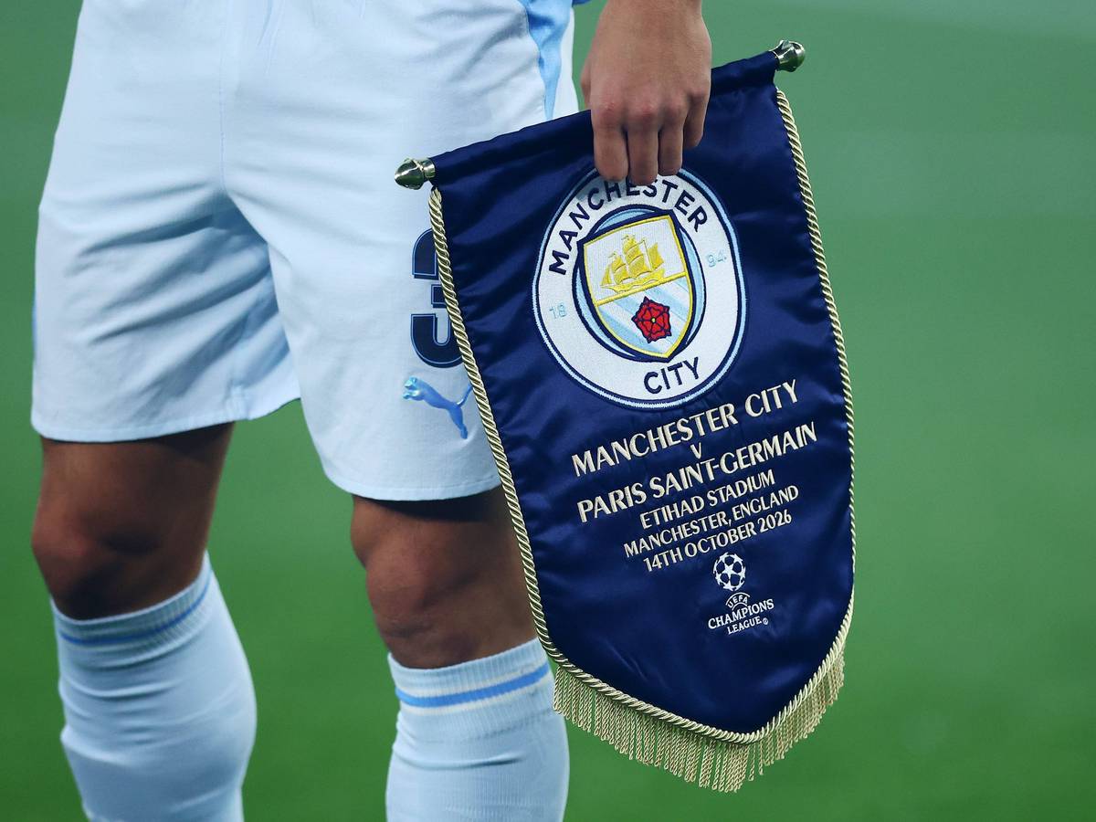 Ein Profi von Manchester City trägt das Vereinslogo auf einem Wimpel.