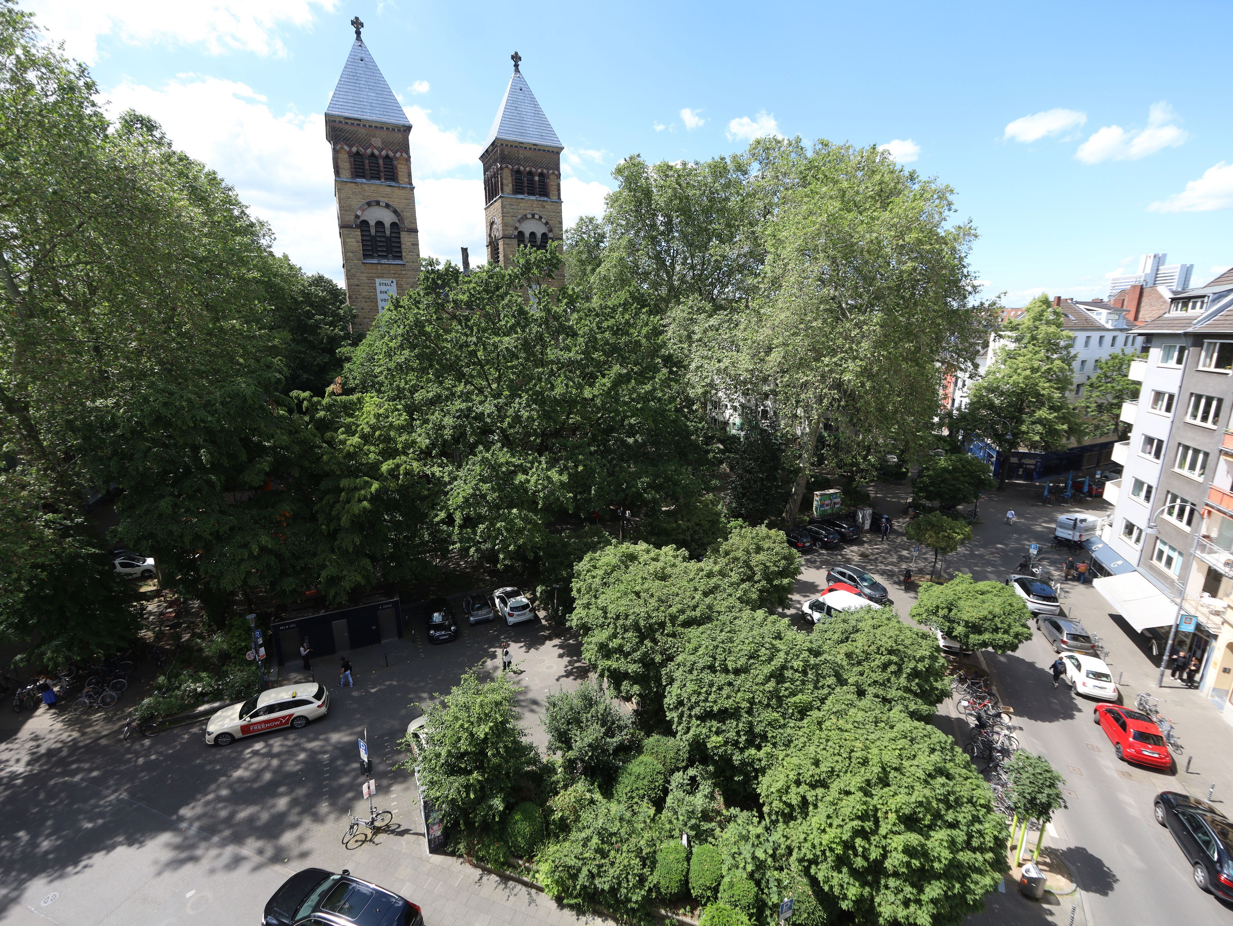 Blick auf den Brüsseler Platz: Der Platz im Belgischen Viertel mit der Kirche St. Michael ist Veedelsmittelpunkt und zugleich Streitpunkt zwischen Anwohnern, Gastronomen und Feiernden.