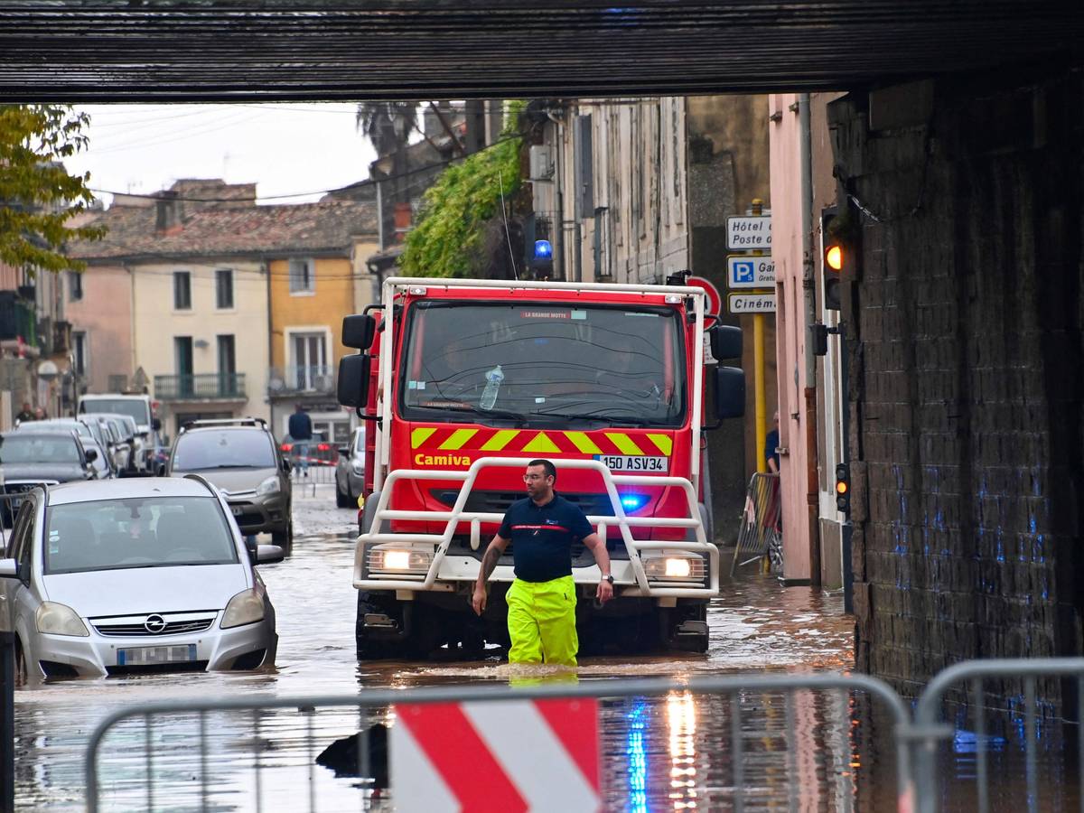 Ein Feuerwehrmann geht nach starken Regenfällen durch eine überflutete Straße in Lunel bei Montpellier in Südfrankreich.