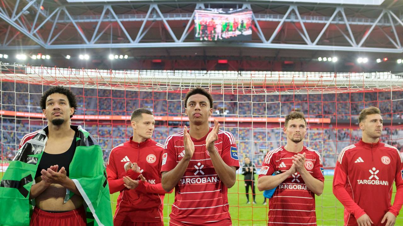 Die Spieler von Fortuna Düsseldorf stehen vor der Kurve und klatschen in ihre Hände.