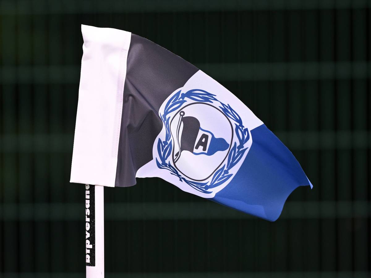 Eckfahne mit dem Logo von Arminia Bielefeld vor scharzem Hintergrund.