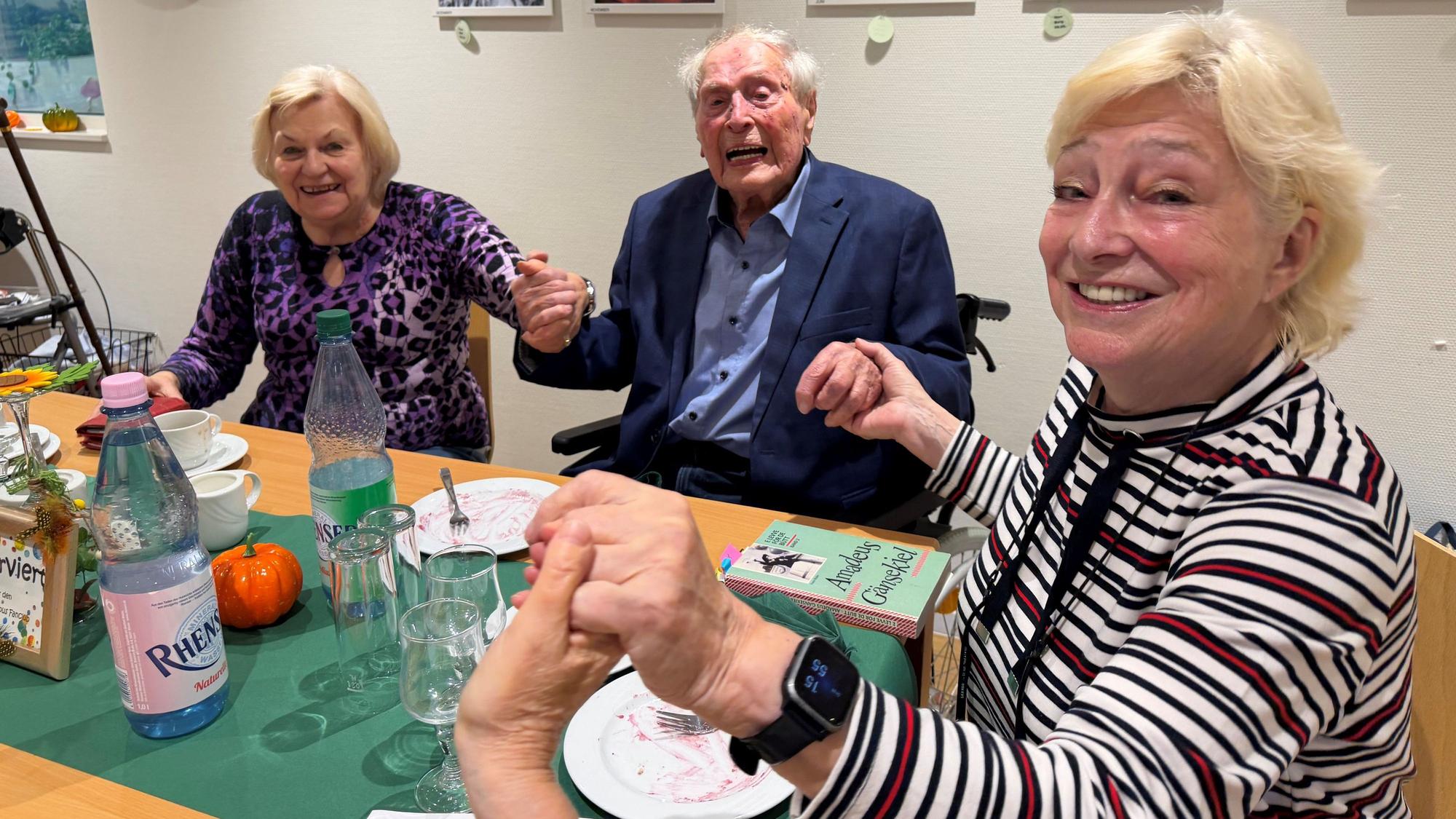 Inge Hellwig, Ludwig Sebus und Renate Baum schunkeln zusammen.