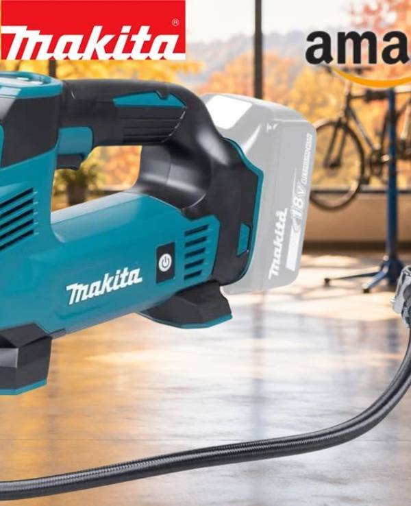 Makita DMP180Z Akku-Kompressor vor Fahrradwerkstatt im Hintergrund.