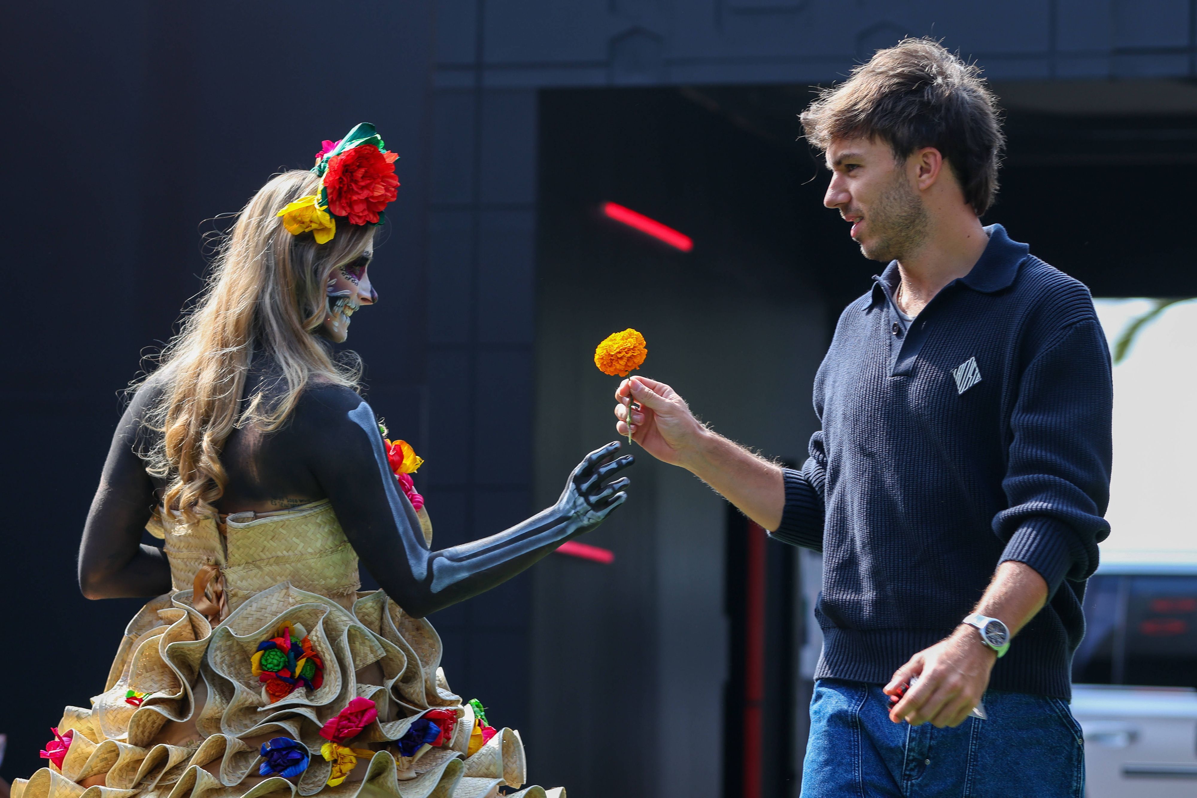 Pierre Gasly bekommt von einer für den Dia de los Muertos kostümierten Frau eine Blume.