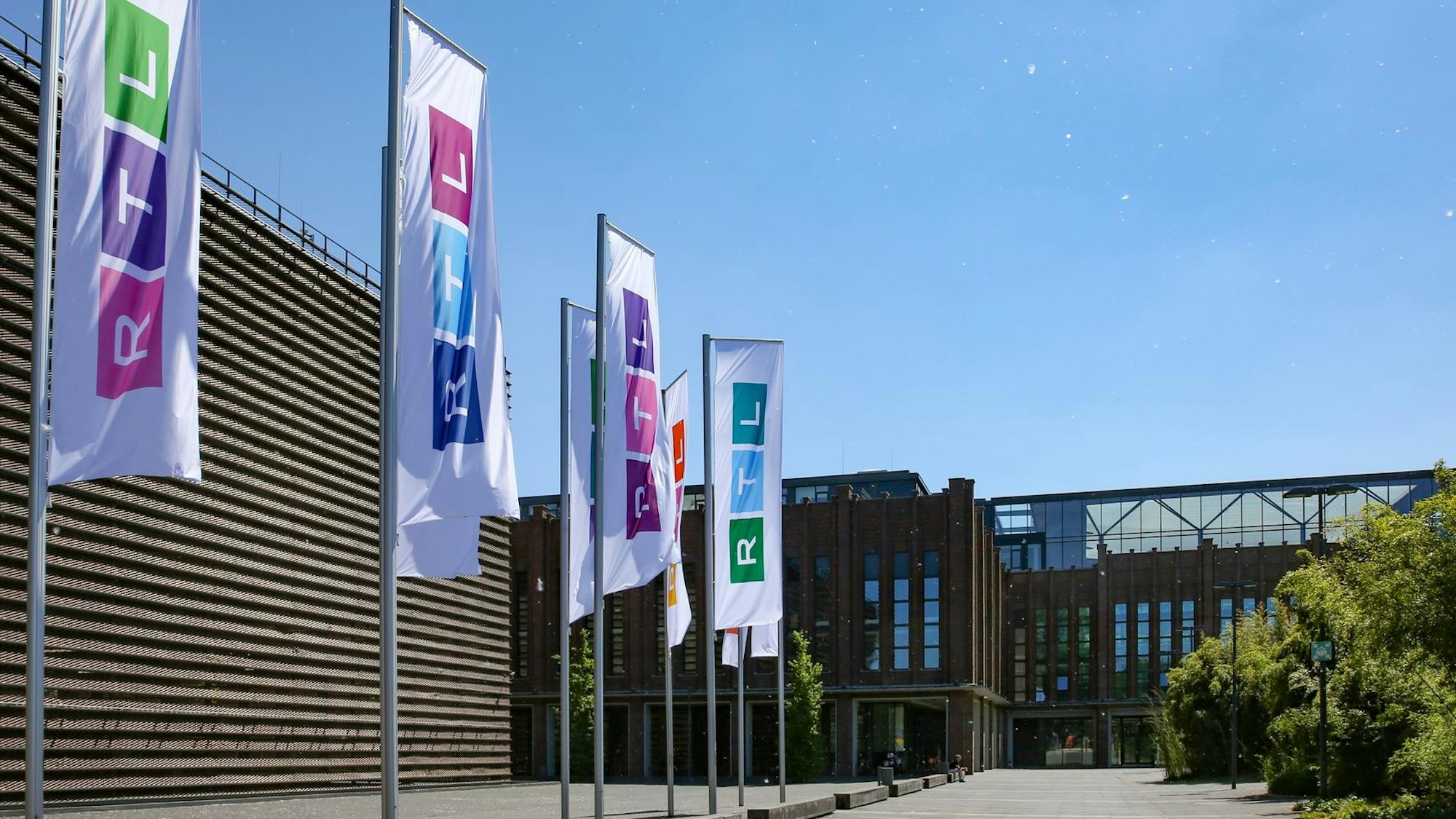 Die Fahnen am RTL-Sitz in Köln-Deutz sind bereits ausgetauscht. Auf jeder Fahne sind andere Farben angeordnet. Das Foto wurde am Sonntag (13. Juni) aufgenommen.