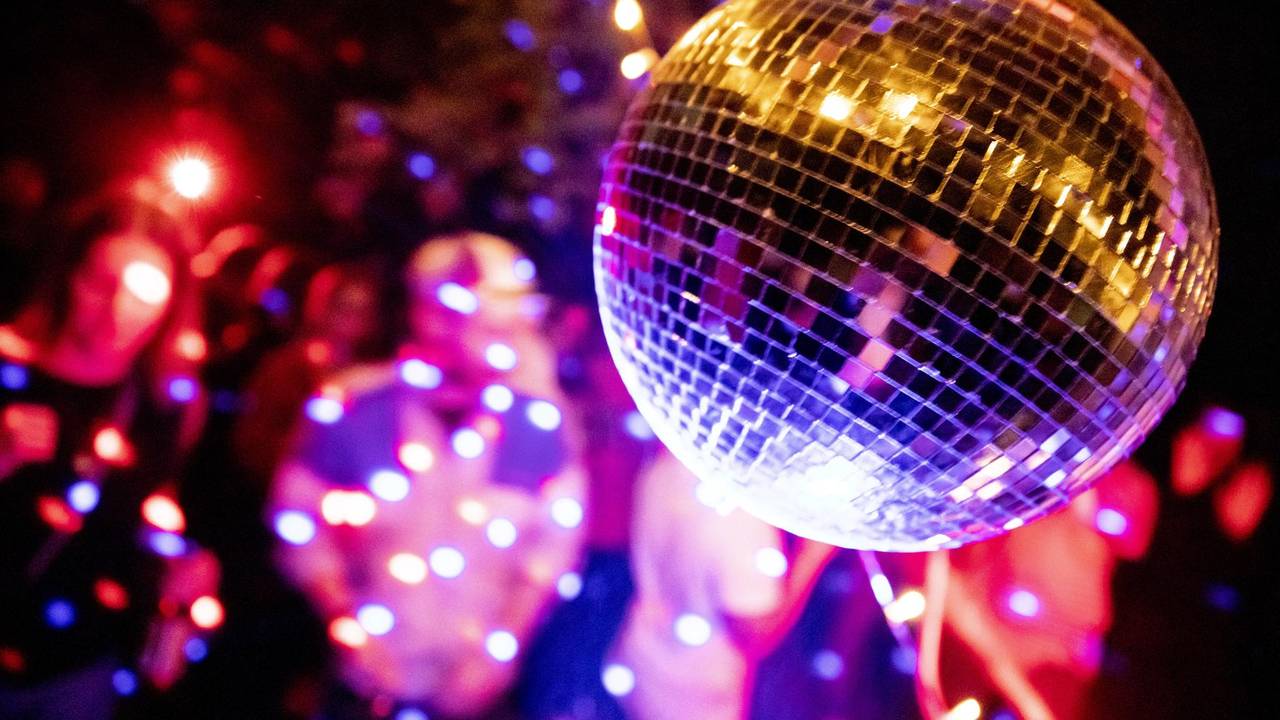 Eine Diskokugel dreht sich bei einer Party.