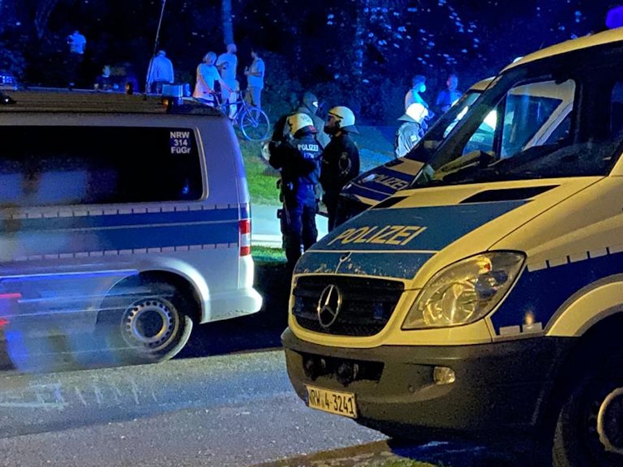 Mannschaftswagen der Kölner Polizei und Beamte stehen am Aachener Weiher.