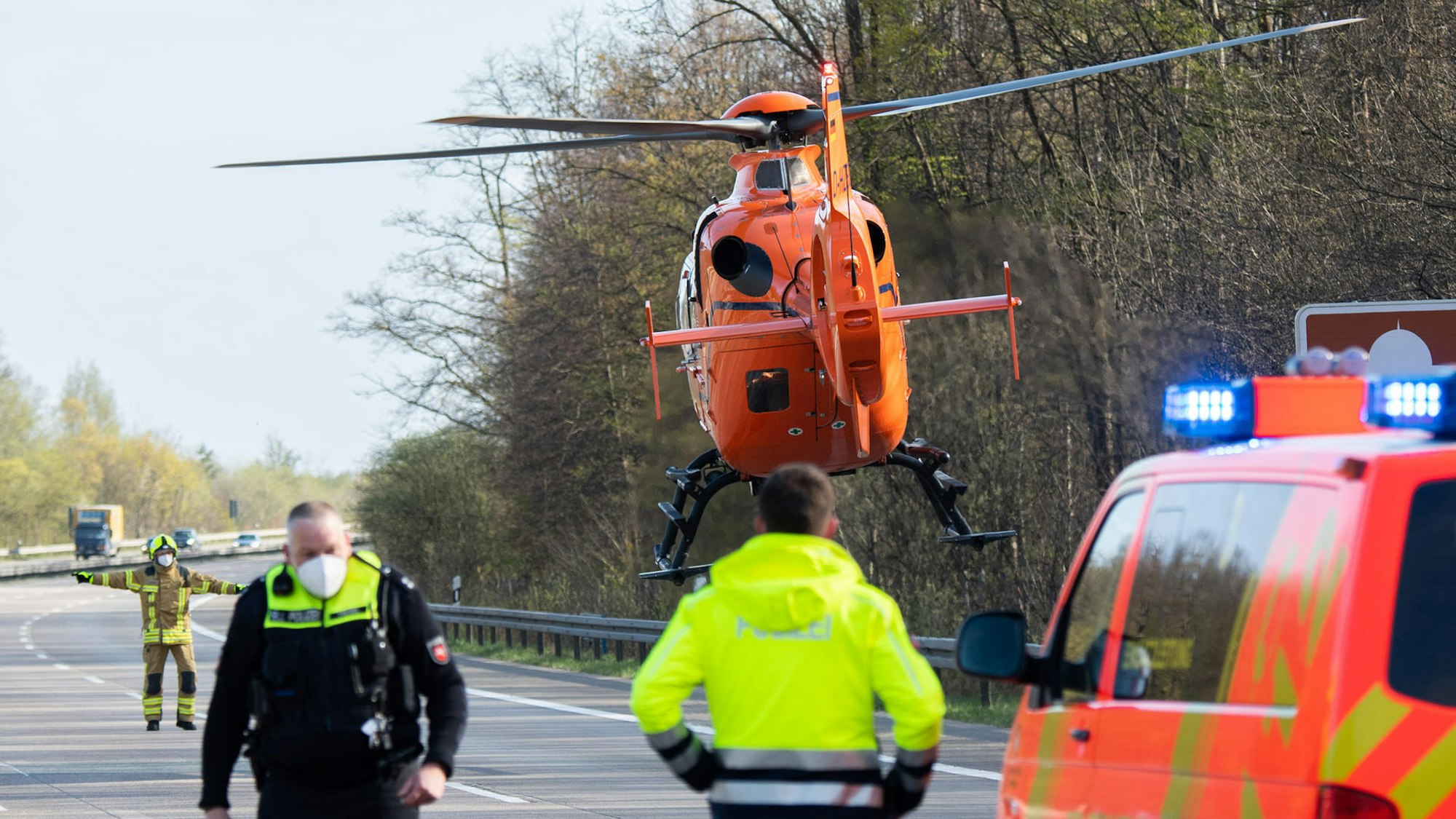 Ein Rettungshubschrauber landet auf einer Autobahn.
