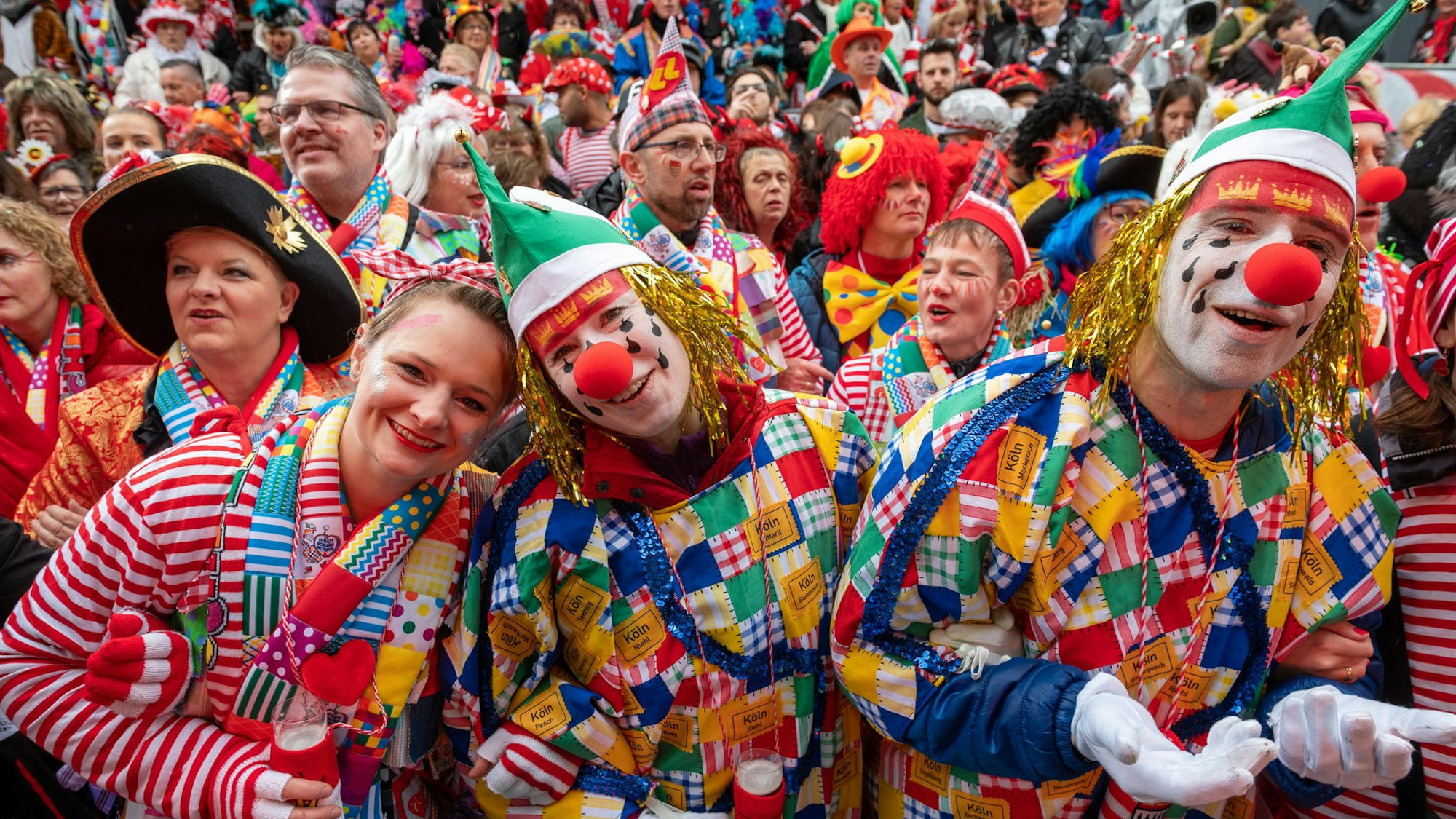 Schunkelnde Jecken an Weiberfastnacht auf dem Alter Markt in Köln