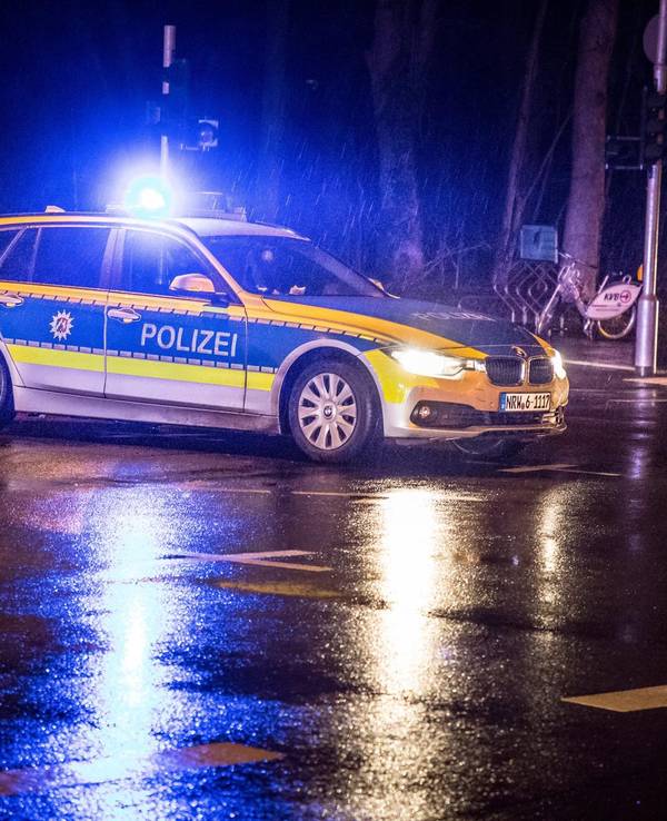 Ein Polizeifahrzeug mit Blaulicht auf einer Kreuzung.
