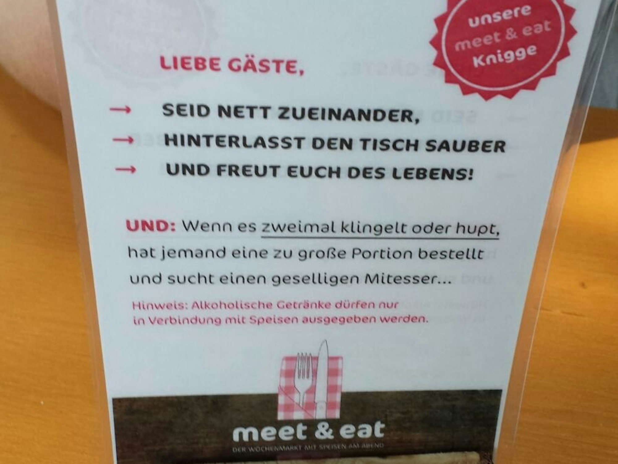Auf einer Karte steht, wie man sich zu verhalten hat: Seid nett zueinander, hinterlasst den Tisch sauber und freut euch des Lebens.