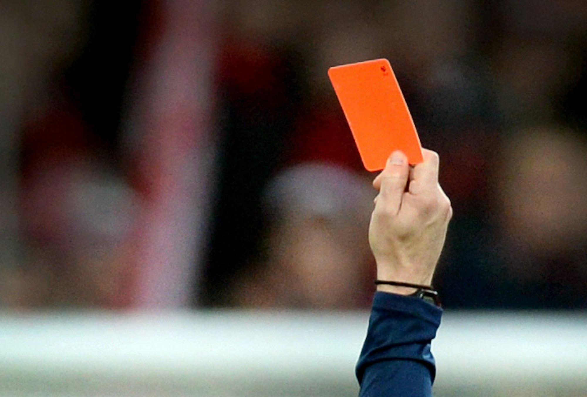 Das Symbolbild zeigt eine Rote Karte in der Hand eines Schiedsrichters bei einem Fußballspiel in Freiburg.