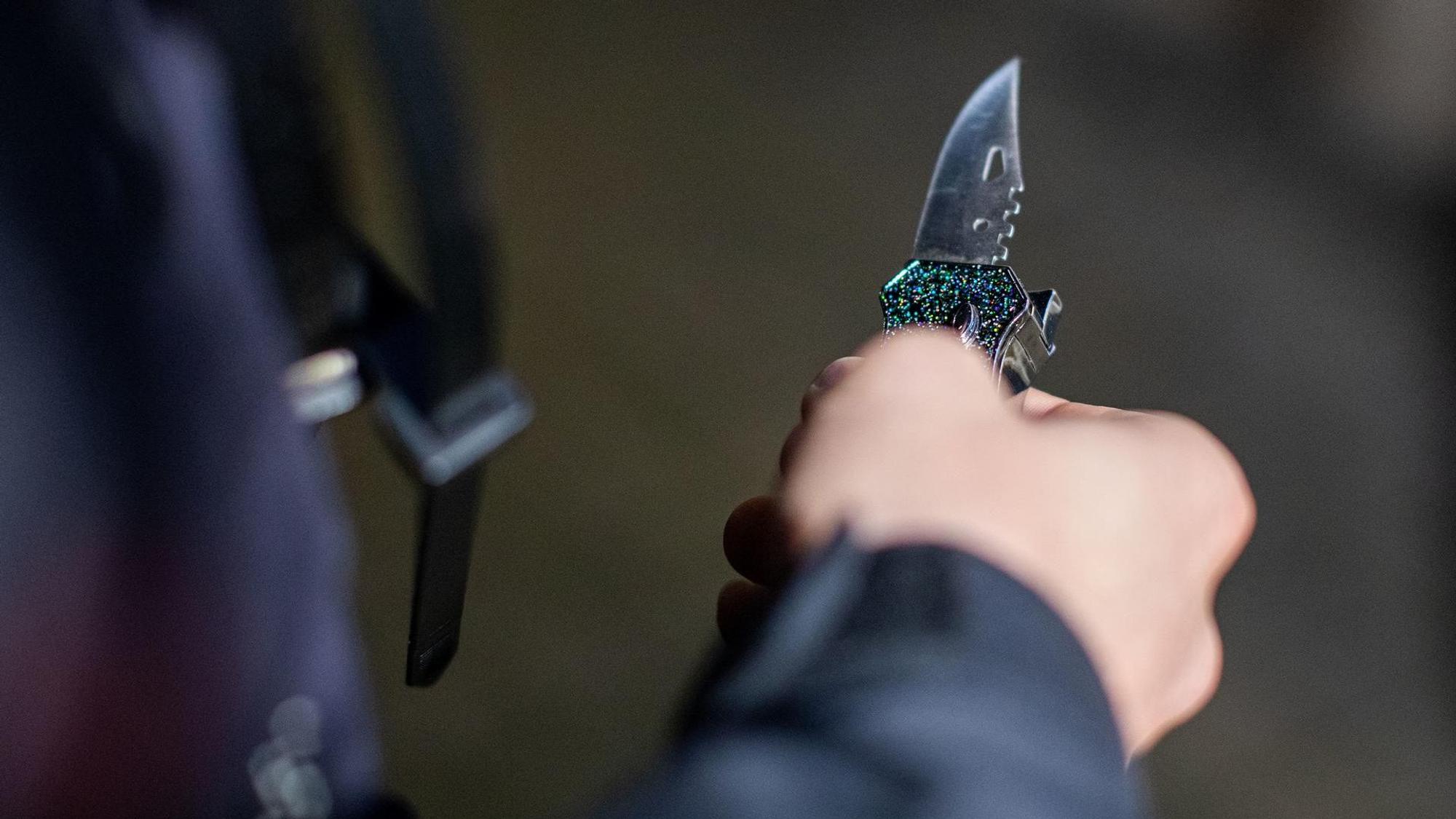 Ein Mann hält ein Messer.