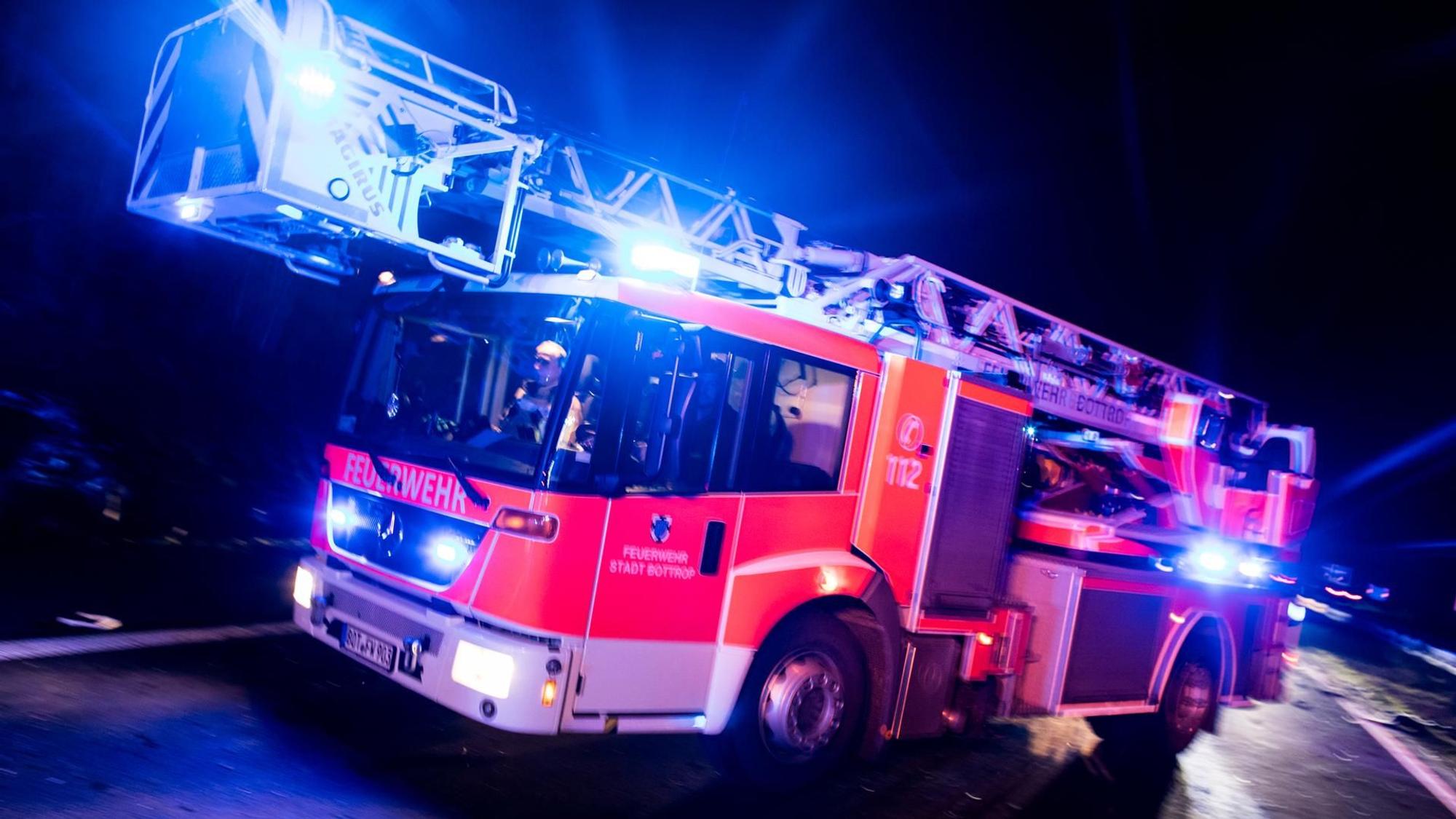 Dieses undatierte Symbolbild zeigt einen Drehleiterwagen der Feuerwehr, der mit Blaulicht fährt.