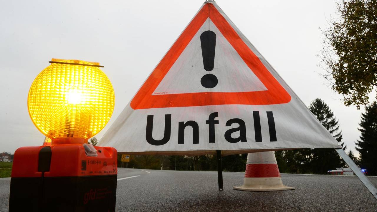 Ein Warndreieck steht auf einer Straße.