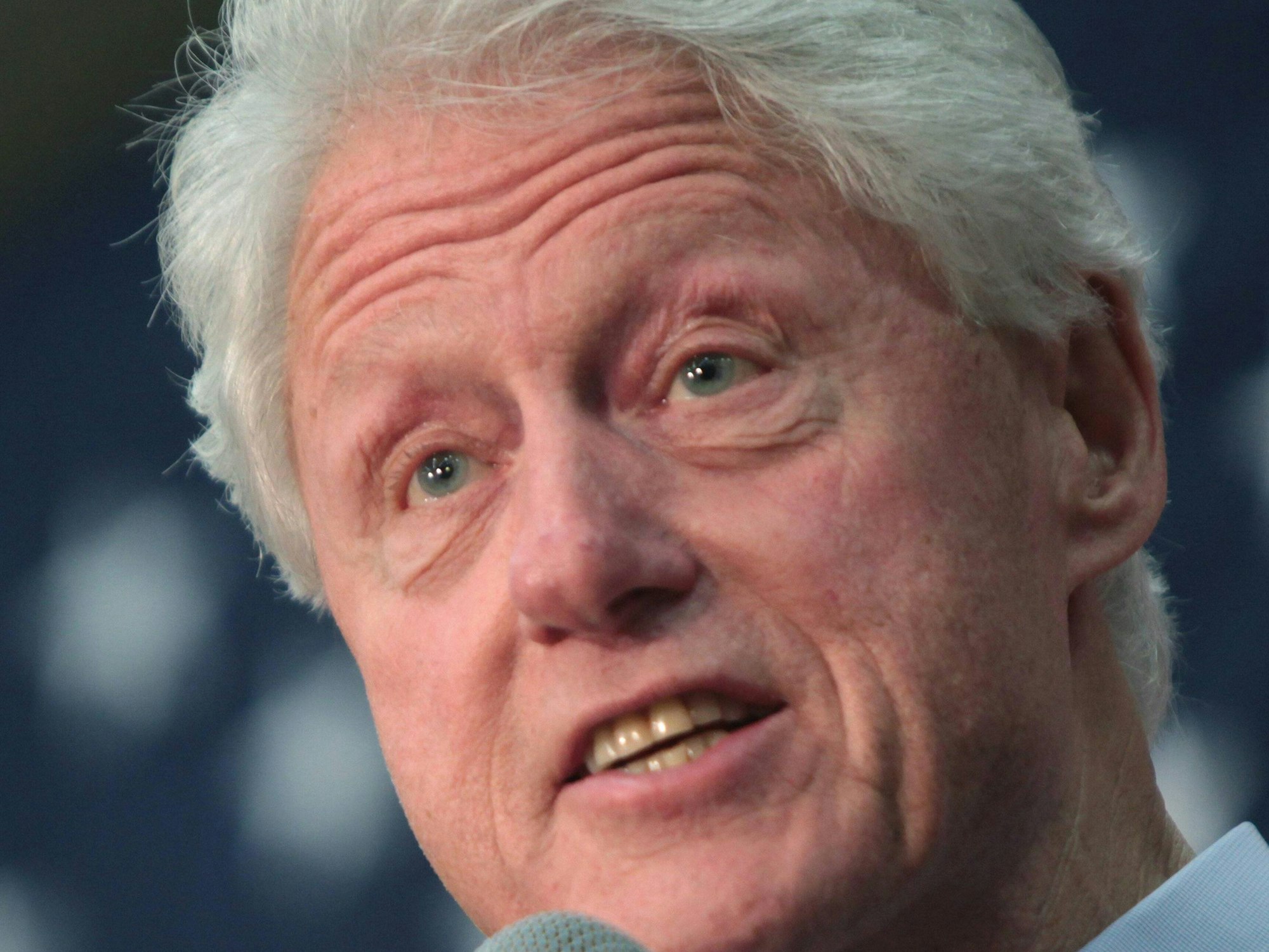 Bill Clinton spricht bei einem seiner Auftritte ins Mirko.