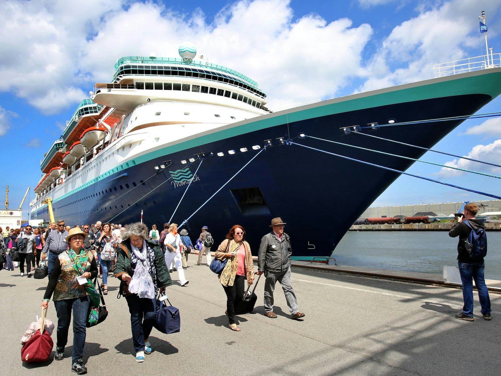 Gäste verlassen ein Kreuzfahrtschiff am Hafen.